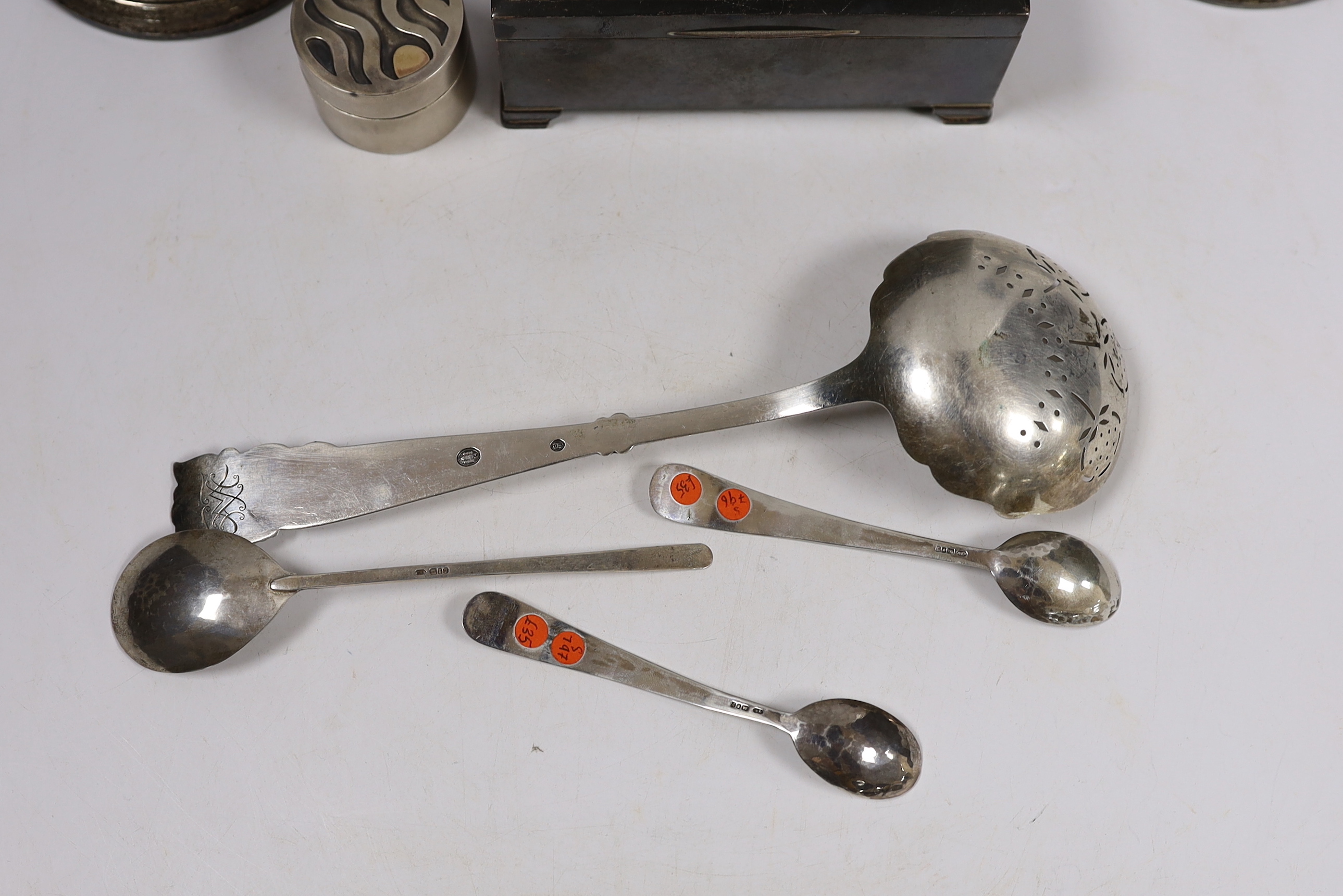 Sundry silver including a cigarette box, pair of dwarf candlesticks, modern silver circular pill box and three spoons, maker GR and a large early 20th century stylish Swedish white metal sifter ladle.